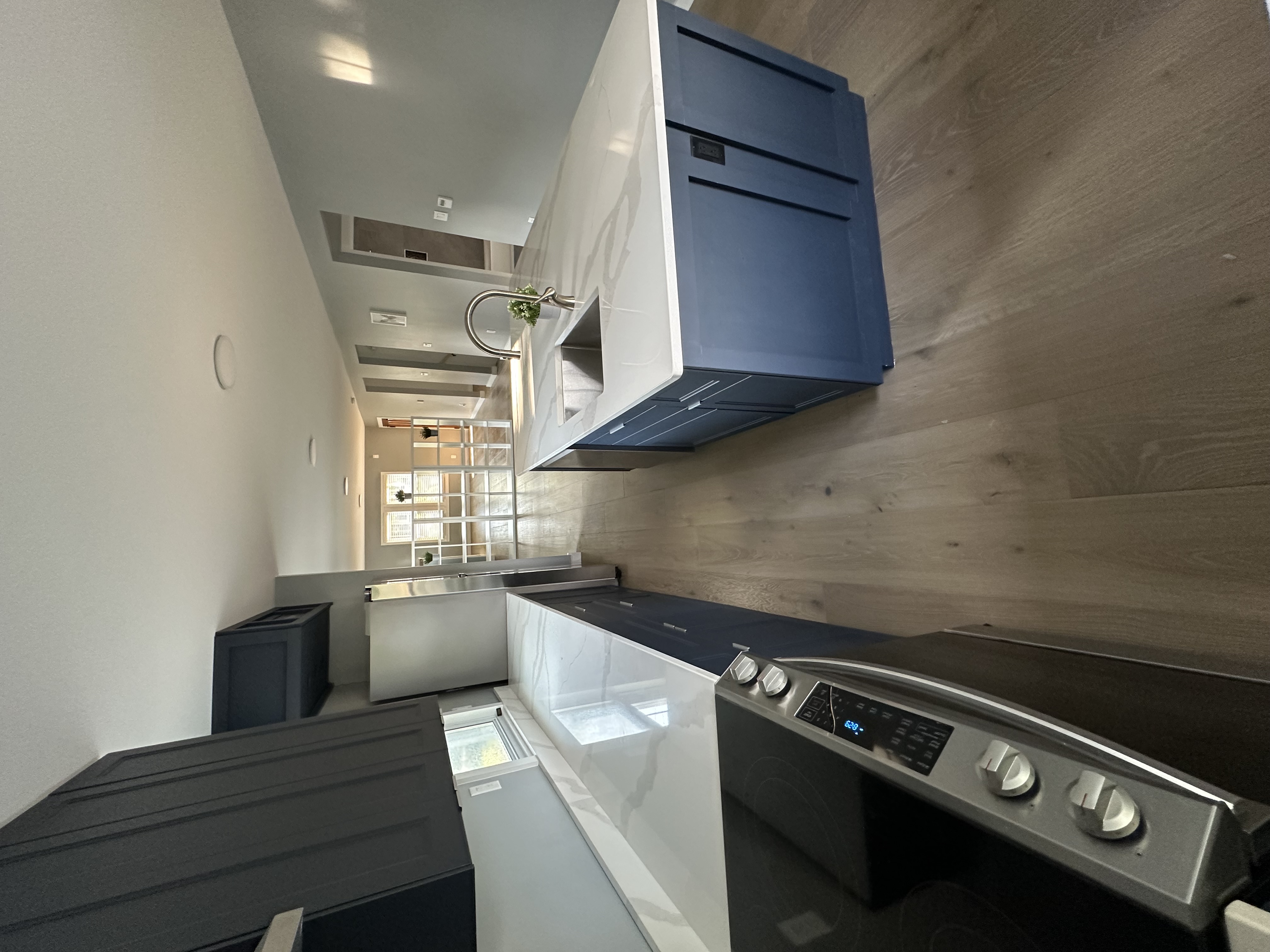 Kitchen — extended counter run along the window wall with the range